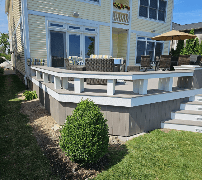 a large, well-maintained backyard with a deck and patio area a large, well-maintained backyard with a deck and patio area